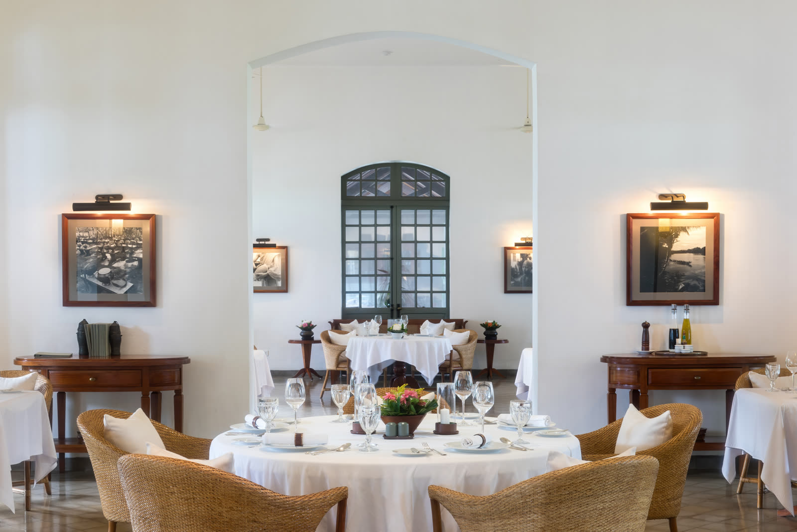 Detail of an elegantly set table with plates and glasses in a warm setting