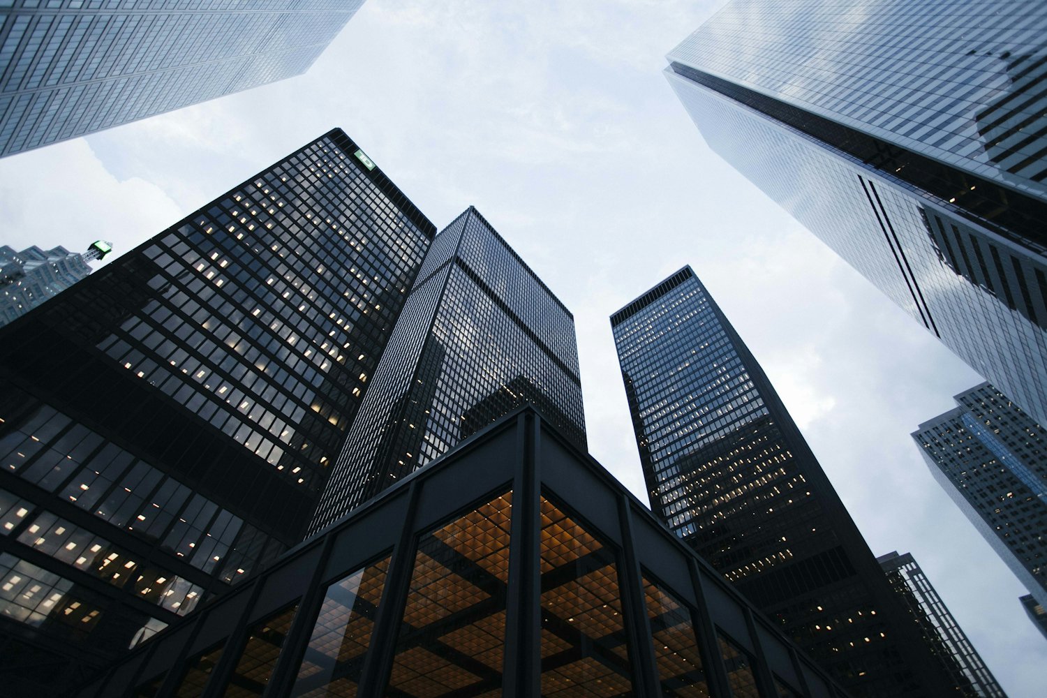 Black glass skyscrapers seen from the street looking upward